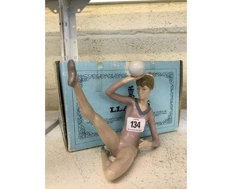 A Lladro china figure modelled as a Young Female Gymnast balancing a ball (5.332) with box.