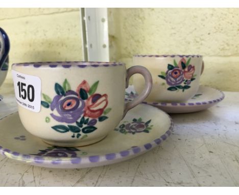 A pair of Carter Stabler Adams Limited red bodied Poole Pottery cups and saucers, decorated in the WW pattern.