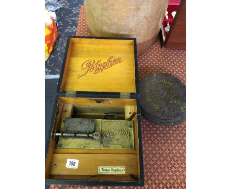 A late 19th century Polyphon Tempo-Regulator disc player together with a small quantity of various metal disc.