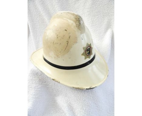 MID 20TH CENTURY FIRE BRIGADE HELMET & ANOTHER Treated linen black helmet with top comb and embossed Hertfordshire badges. To