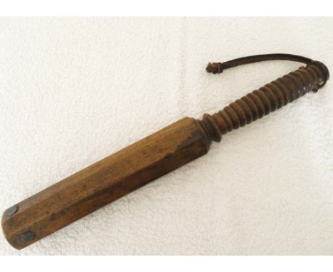 OCTAGONAL WOODEN POLICE TRUNCHEON Late Victorian wood baton of octagonal shape. Turned handle and leather wrist strap. Approx