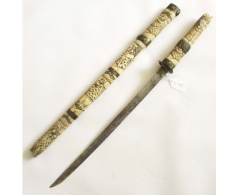 JAPANESE BONE AND BRASS MOUNTED SHORT SWORD Sword of 16 inches in a carved and polychromed bone scabbard, decorated with bras