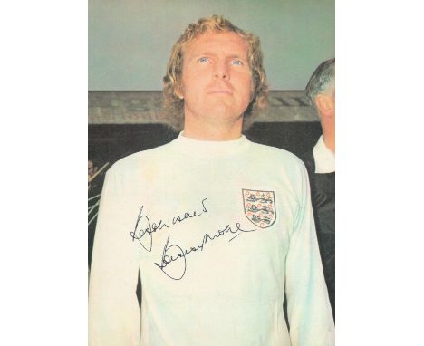 Bobby Moore signed 10x7 inch colour magazine photo pictured while playing for England.  Good Condition. All autographs come w