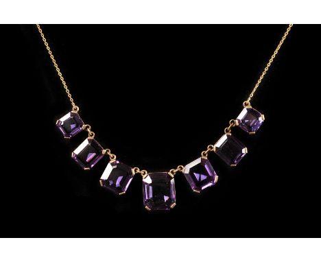 A vintage alexandrite style fringe necklace, having seven graduating synthetic colour changing alexandrites in pierced box fr