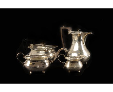 An Edwardian four piece silver tea set, three pieces marked London 1902, one Sheffield 1903, all by William Hutton & Sons Ltd
