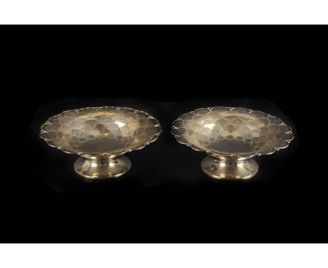 A pair of George V small silver footed bowls by Mappin & Webb, Sheffield 1935, each with scale decoration to a circular foot,