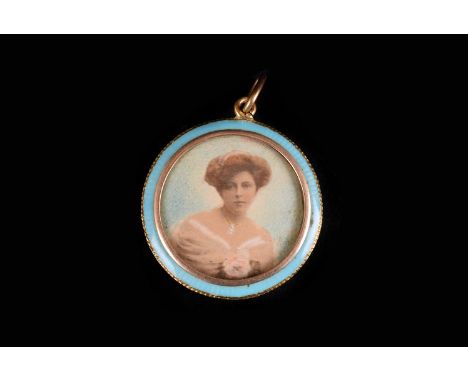 An Edwardian gold and enamel portrait locket pendant, the circular mount having turquoise enamel surround and photogravure bu