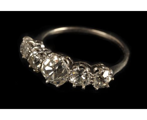 A vintage five stone diamond engagement ring, having a larger old cut flanked with two further old cuts to each side, in claw