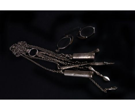 A late 19th century Dutch silver chatelaine, the shaped and pierced ornate belt clip supporting seven chains and having two c