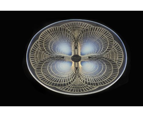 A Rene Lalique “Coquilles” pattern moulded opalescent glass footed plate, c.1920, with four moulded opalescent shells forming