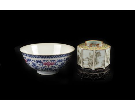 A Chinese porcelain bowl, decorated with puce enamel bats to a stylised floral ground, Qianlong seal mark to the base 17cm di