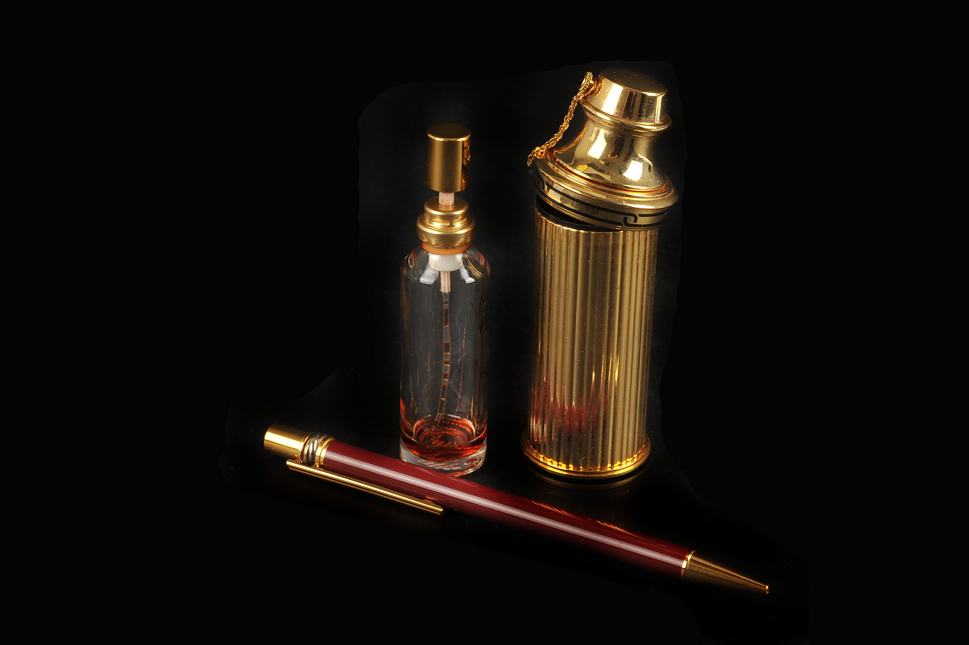 A Must De Cartier Perfume Atomiser Together With A Gold Plated And