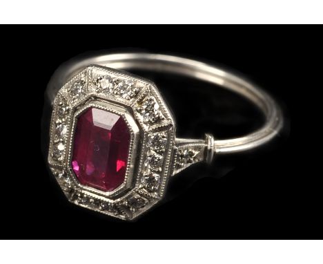 An Art Deco style ruby and diamond dress ring, the white metal mount having octagonal tablet set with brilliant cuts and cent