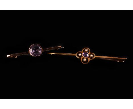 Two vintage gold and amethyst bar brooches, one 9ct gold with a large purple single stone, the other in 15ct gold with quatre