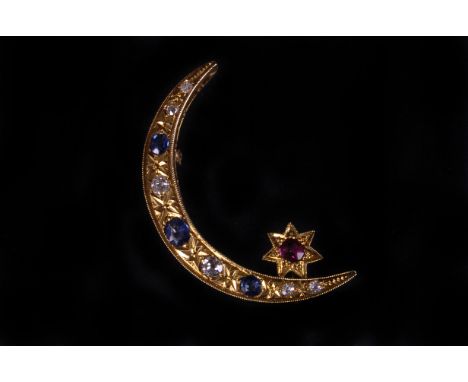 A gold and gem set crescent shaped brooch, having old cut diamonds and synthetic sapphire and a ruby, in a vintage James Walk