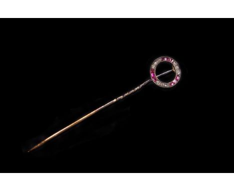 A fine Edwardian ruby and diamond stick pin, having a circle of square cut rubies and diamonds, presented in a Henry Tessier 