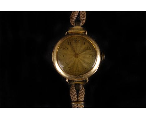 A vintage 18ct gold Rolex ladies wristwatch, circular case with silvered engine turned dial, on cotton strap, AF