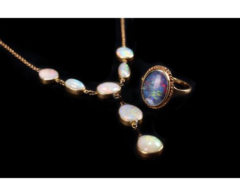 A gold and opal fringe necklace and an opal ring, having five oval polished stones above a drop of two further opals, support