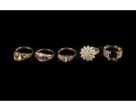 Five modern 9ct gold and gem set dress rings, including an opal cluster example, a smoky quartz ring with pierced shoulders, 