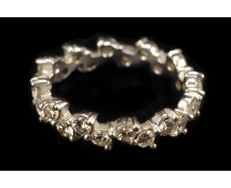 A pretty 18ct gold and diamond full eternity ring, the white gold mount in wavy design set with brilliant cuts in claw mounts