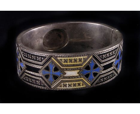 A vintage silver and enamel bangle, the thick hinged bracelet with cross and banded champlevé style coloured designs, with sa