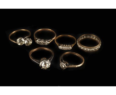 A group of vintage gold and silver rings, including a large solitaire, a large two stone crossover, a full eternity and three