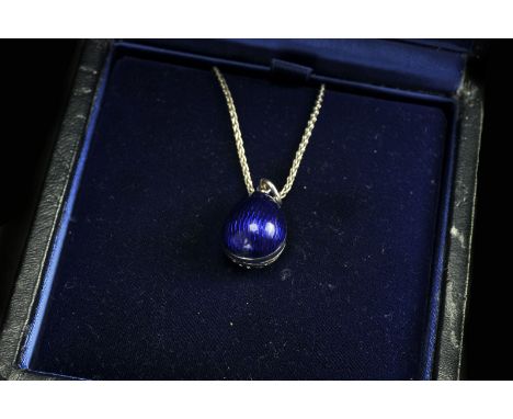 A modern Russian limited edition 18ct gold and enamel pendant from Faberge, the egg shaped pendant having blue enamel ground 