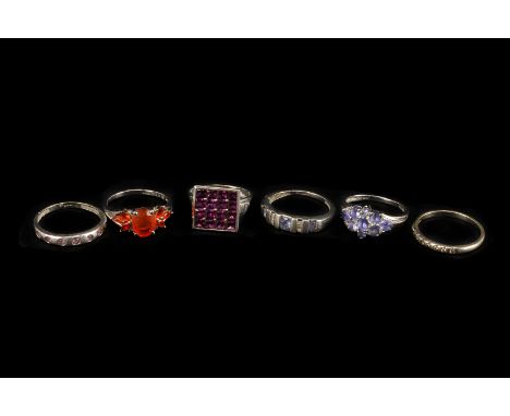 Six modern white 9ct gold and gem set dress rings, including an example with square tablet set with red stones, a cluster wit