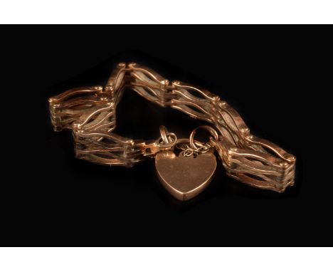 A vintage 9ct gold bracelet, having riveted gate link section united by heart shaped lock clasp and safety chain, approx. 22g