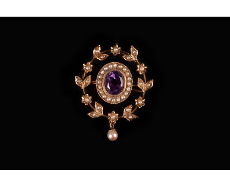 An Edwardian period 9ct gold amethyst and pearl pendant, centred with a large purple stone in surround of seed pearls the out