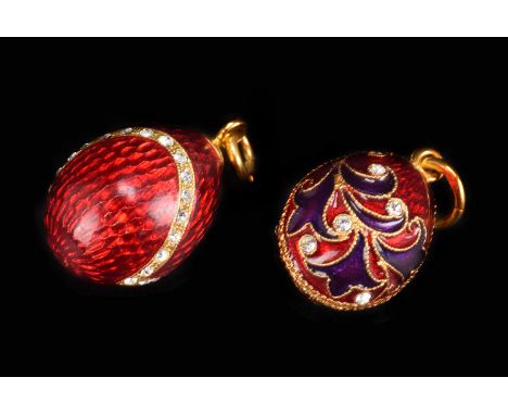 Two modern enamel pendants, both the egg shaped red enamel forms set with paste stones and marked to the loop bales (2)