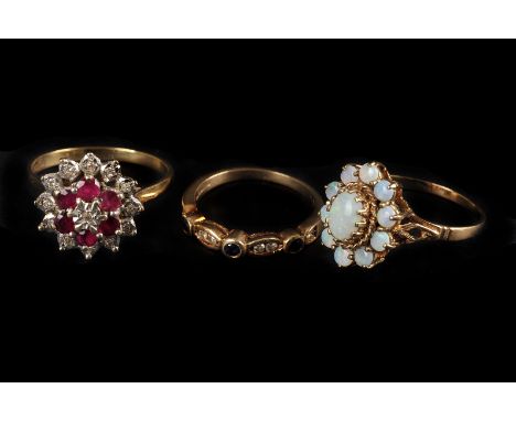 Three modern 9ct gold and gem set dress rings, one being an opal cluster, one cluster set with red and clear stones, the othe