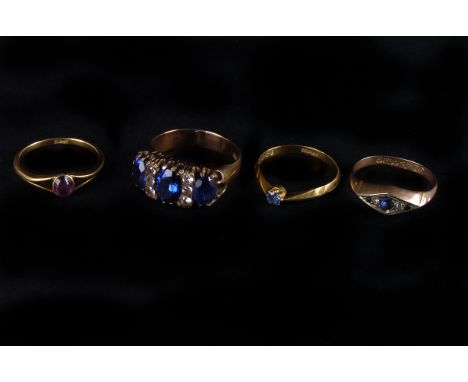 Four vintage gold and gem set rings, including an 18ct gold and blue stone solitaire, an amethyst solitaire and two 9ct gold 
