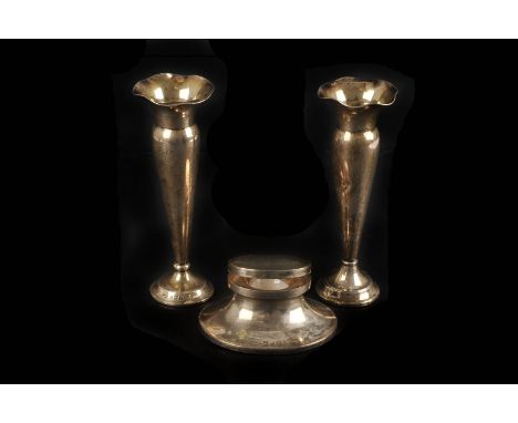 A silver capstan inkwell by William Neale & Son, Birmingham 1915, 10cm long, together with a pair of silver spill vases (3)