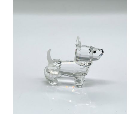 Sparkling clear faceted crystal figure of a dog standing looking ahead; frosted tail. Swarovski mark. This item has its origi