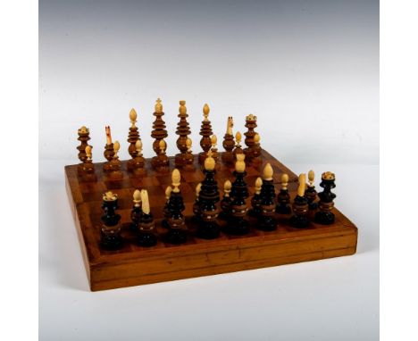 A set that consist of wooden chessboard, also used a storage for the pieces. The 32 black and white chess pieces are made up 