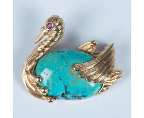 Beautiful small bird brooch made from 14k gold with a turquoise cabochon body and ruby eye. It is stamped 14k on the back and