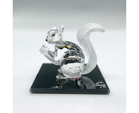Clear faceted crystal figure of a squirrel holding a crystal. Includes artist signed black glass base, 3"W x 3"L. This item h