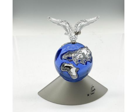 Celebratory figure of a blue crystal Earth showing the continents in clear crystal with dove perched with branch in his beak.