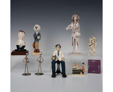 This diverse grouping showcases unique handcrafted sculptures, such as D. Manning's whimsical shelf sitter, Doggies' pharmaci