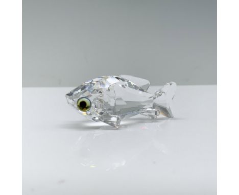 A clear crystal fish gracefully positioned as if swimming, adorned with melon-colored eyes and delicate fins. Swarovski backs