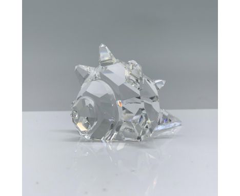 A clear crystal conch shell decorated with unique crystal points and a spiral design on the larger end. Swarovski backstamp. 