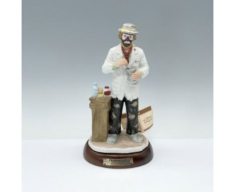 Figurine depicts Emmett Kelly Jr. in traditional clown make up dressed and acting like a pharmacist. Emmett Kelly Jr. backsta