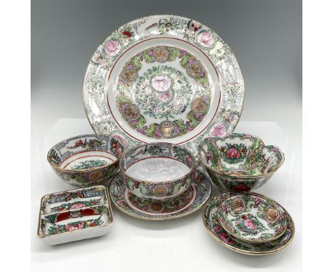 Hand decorated in Hong Kong with lighter colored rose enhanced by gilding within the leaf and floral design and on rim. Set i