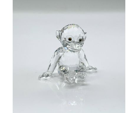 Sparkling clear faceted crystal figure of a young chimpanzee sitting looking attentive. Swarovski mark. This item has its ori