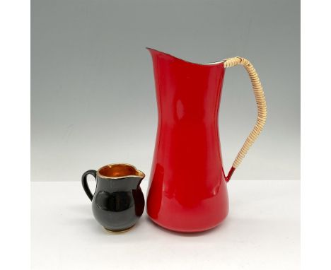 Orange metal pitcher with wrapped handle 8.25"H and small black ceramic creamer with gold toned interior 3"H. Dansk and Confe