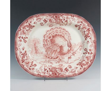 Featuring a gorgeous serving platter in Tonquin Red with a white background, showcasing a majestic turkey at the center and d