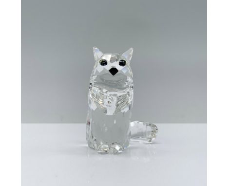 An exquisite clear crystal cat, boasting melon-colored crystal eyes and a sleek black crystal nose, elegantly seated with its