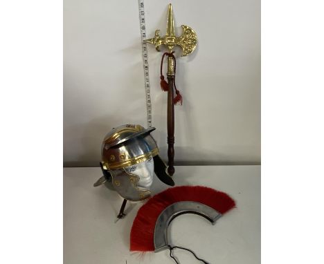 A replica Roman soldiers helmet with a novelty brass headed axe. shipping unavailable