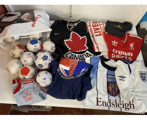 A selection of assorted sports clothing and a large selection of novelty small footballs